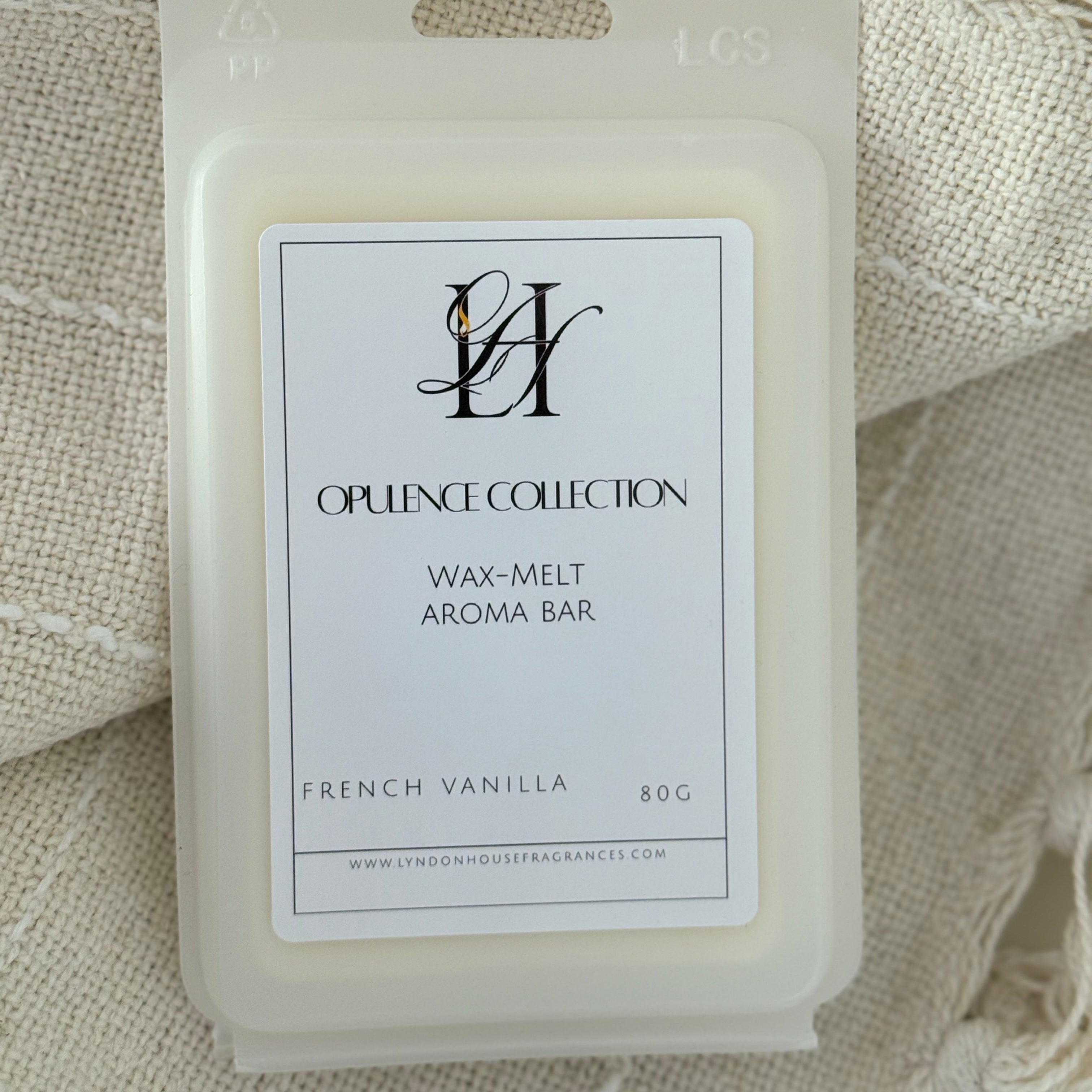 A packaged wax melt aroma bar from Lyndon House Fragrances Opulence Collection, labeled 'French Vanilla 80G', resting on a textured cream-colored woven blanket.